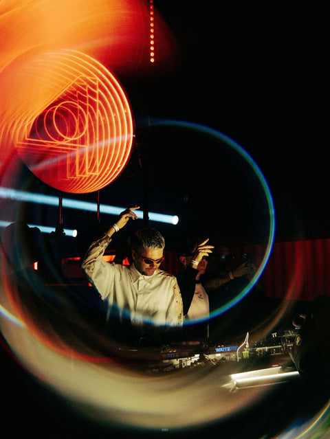 DJ at a club with his arms in the air