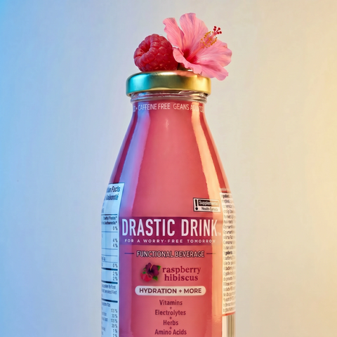 Bottle of 'Drastic Drink' with raspberry and hibiscus on a gradient background
